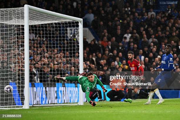 Bruno Fernandes of Manchester United scores his team's second goal as Djordje Petrovic of Chelsea looks on after failing to make a save during the...