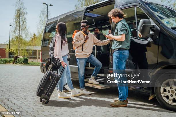 group of students getting on a minibus - school bus stock pictures, royalty-free photos & images