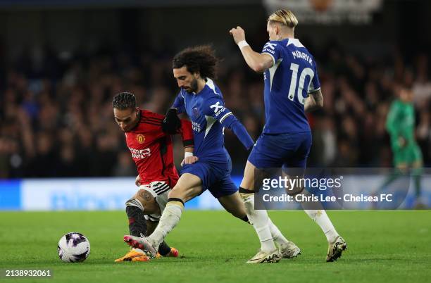 Antony of Manchester United is challenged by Marc Cucurella of Chelsea as Mykhaylo Mudryk looks on during the Premier League match between Chelsea FC...