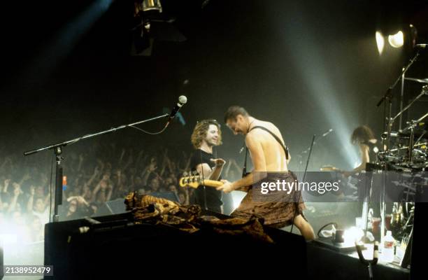 The crowd watches Michael Hutchence , Garry Gary Beers and Tim Farriss, of the Australian rock band INXS, on stage during a concert in Los Angeles,...