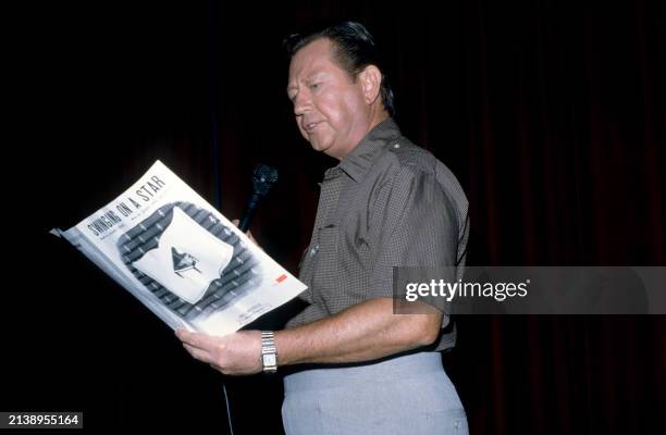 American dancer and singer Donald O'Connor reads the lyrics of 'Swinging On A Star' in Los Angeles, California, circa 1990.