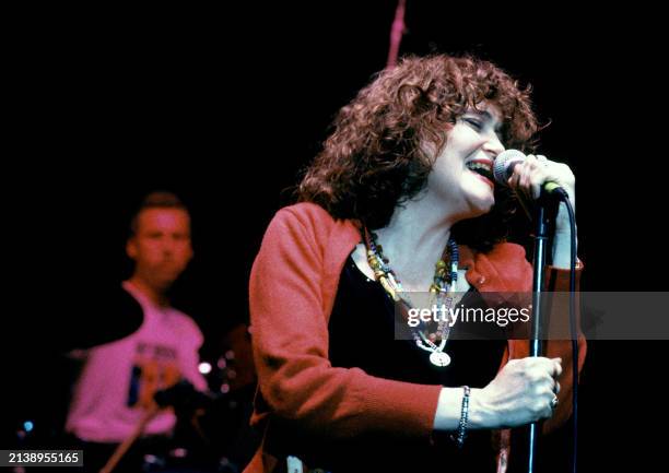 American singer Exene Cervenka, of the American punk rock band X, sings on stage during a concert in Los Angeles, California, circa 1990.