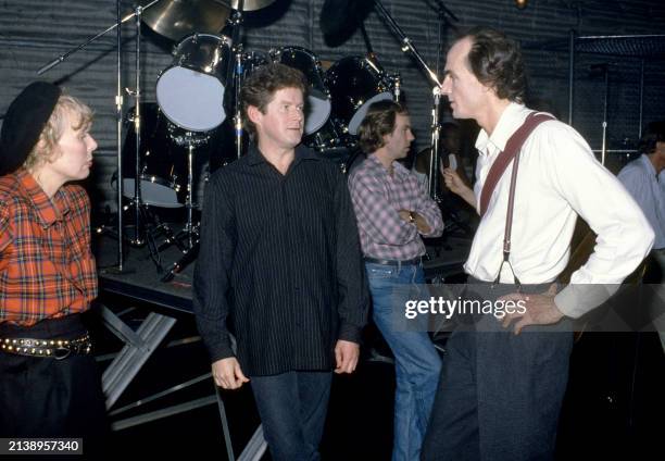 Canadian-American musician Joni Mitchell, American musicians Don Henley and James Taylor talk in Los Angeles, California, circa 1990.