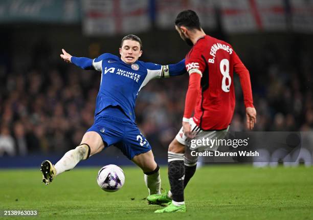 Conor Gallagher of Chelsea attempts to block Bruno Fernandes of Manchester United as he passes the ball during the Premier League match between...