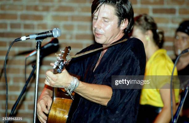 American singer John Doe , of the American punk rock band X, plays on stage in Los Angeles, California, circa 1990.
