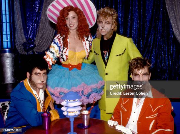 Musicians Lee Rocker, Brian Setzer and Slim Jim Phantom, of the American rockabilly band The Stray Cats, dressed in cat attire, pose for a portrait...