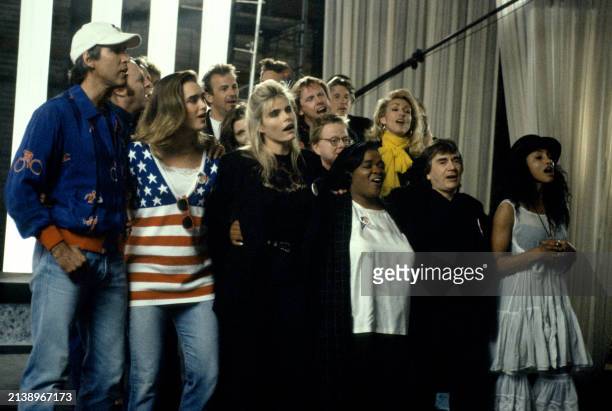 Part of a group of over 100 celebrities sing during a playback of their recorded song 'Voices That Care' at Warner Brothers Studios in Burbank,...