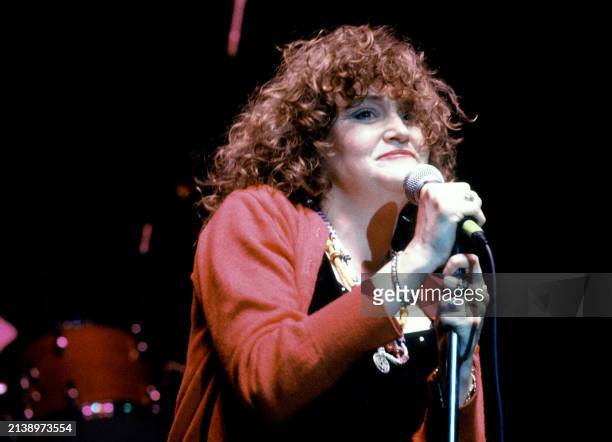 American singer Exene Cervenka, of the American punk rock band X, sings on stage during a concert in Los Angeles, California, circa 1990.