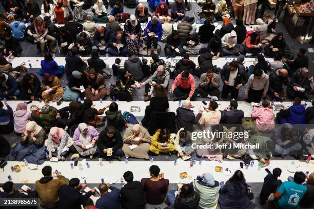 Members of the public have a communal meal at and Iftar event in the V&A museum on April 04, 2024 in Dundee, Scotland. Open Iftar is organised by the...