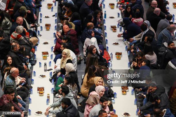 Members of the public break the fast ahead of the call to prayer at an Iftar event in the V&A museum on April 04, 2024 in Dundee, Scotland. Open...