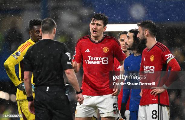 Referee Jarred Gillett looks on as he is confronted by Harry Maguire of Manchester United after the Premier League match between Chelsea FC and...