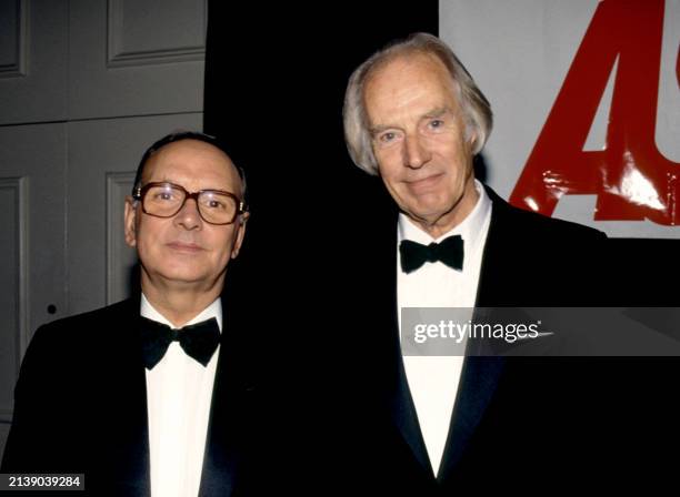 Italian composer Ennio Morricone and English record producer George Martin pose for a portrait at an unspecified event circa 1995.