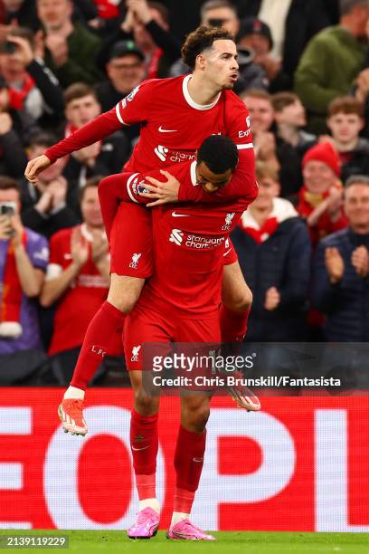 Cody Gakpo of Liverpool celebrates scoring his side's third goal with team-mate Curtis Jones during the Premier League match between Liverpool FC and...