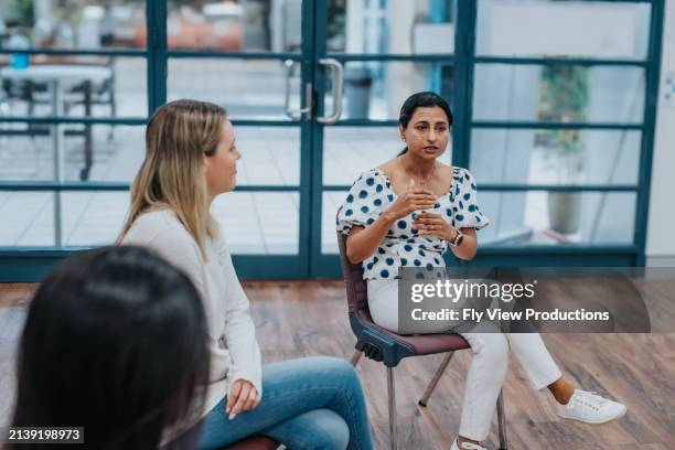 young adult woman sharing life experience in group therapy - indian community stock pictures, royalty-free photos & images