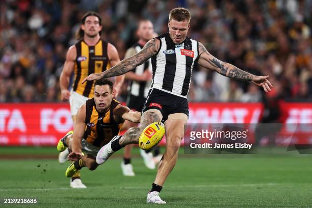 Karl Amon of the Hawks tackles Jordan De Goey of the Magpies during the round four AFL match between Collingwood Magpies and Hawthorn Hawks at...