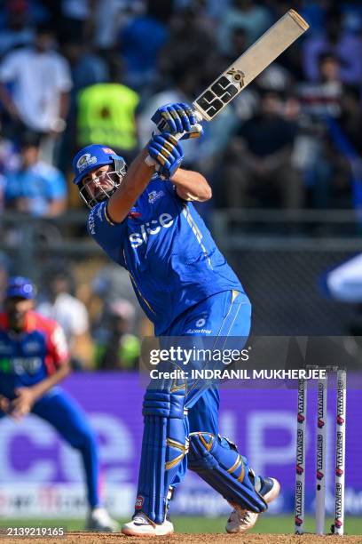 Mumbai Indians' Tim David plays a shot during the Indian Premier League Twenty20 cricket match between Mumbai Indians and Delhi Capitals at the...