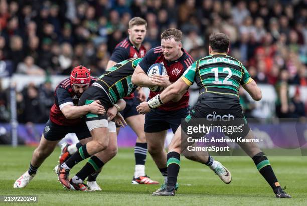 Munster's Sean O'Brien is challenged by Northampton Saints' Burger Odendaal during the Investec Champions Cup Round of 16 match between Northampton...