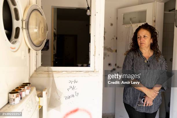 Anat Elkabets stands at the entrance of the house of her daughter, Sivan Elkabetz, who was killed with her boyfriend Naor Hassidim during the October...