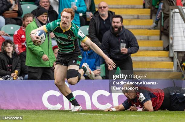 Northampton Saints' George Hendy escapes the clutches of Munster's Simon Zebo and goes on to score his side's fourth try during the Investec...