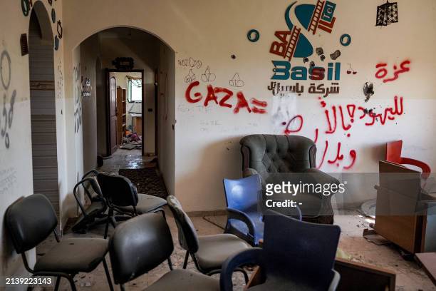 This picture taken on April 7, 2024 shows graffiti left by Israeli forces inside a building in Khan Yunis after Israel pulled its ground forces out...