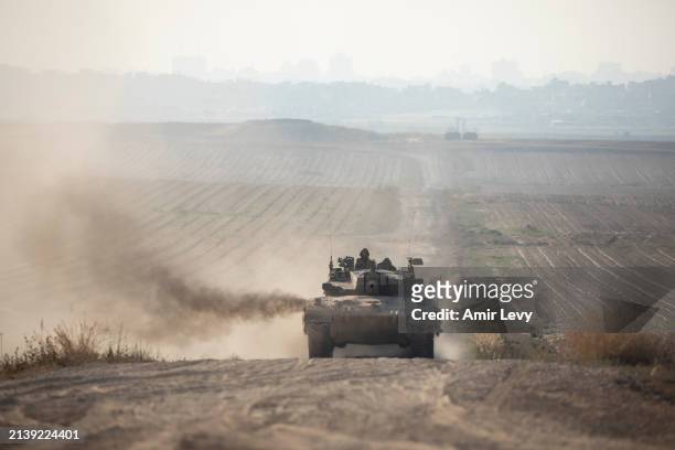An Israeli tank moves a long the border with the Gaza Strip as seen from a position on the Israeli side of the border on April 7, 2024 in Southern...