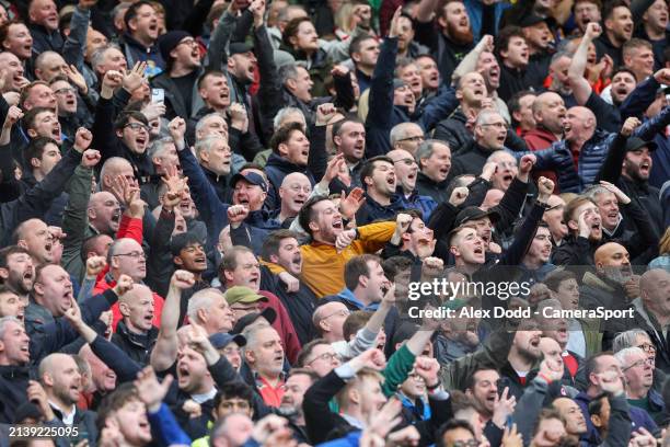 Liverpool fans celebrate their teams goal during the Premier League match between Manchester United and Liverpool FC at Old Trafford on April 7, 2024...