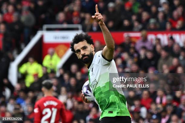 Liverpool's Egyptian striker Mohamed Salah celebrates after scoring their second goal from the penalty spot during the English Premier League...