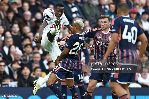 Tottenham Hotspur's Senegalese midfielder Pape Matar Sarr vies with Nottingham Forest's Brazilian midfielder Danilo during the English Premier League...