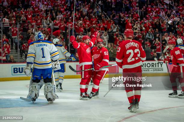 Dylan Larkin of the Detroit Red Wings scores a goal on Ukko-Pekka Luukkonen of the Buffalo Sabres during the first period at Little Caesars Arena on...