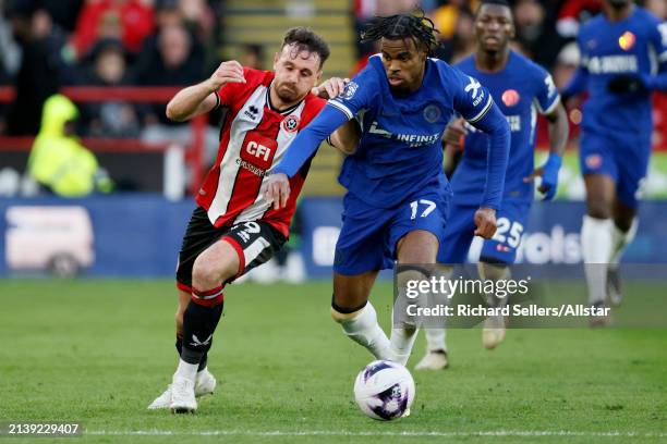 Jack Robinson of Sheffield United and Carney Chukwuemeka of Chelsea challenge during the Premier League match between Sheffield United and Chelsea FC...