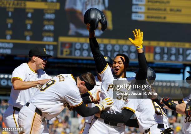 Edward Olivares of the Pittsburgh Pirates celebrates with teammates after defeating the Baltimore Orioles 3-2 during interleague play at PNC Park on...