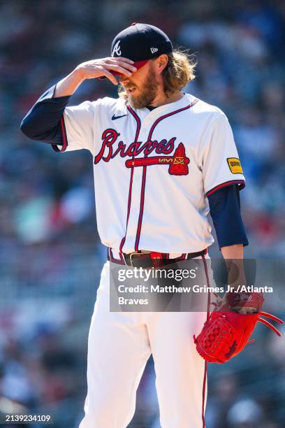 Pierce Johnson of the Atlanta Braves adjusts his hat in the ninth inning against the Arizona Diamondbacks at Truist Park on April 7, 2024 in Atlanta,...