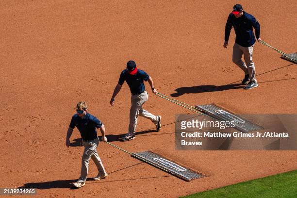 The Atlanta Braves grounds crew drags the field in the seventh inning against the Arizona Diamondbacks at Truist Park on April 7, 2024 in Atlanta,...