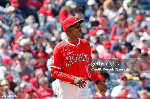 Manager Ron Washington of the Los Angeles Angels walks to the pitching mound to replace relief pitcher José Cisnero during the sixth inning against...