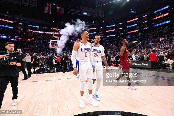 Russell Westbrook of the LA Clippers and Norman Powell of the LA Clippers celebrate after the game against the Cleveland Cavaliers on April 7, 2024...