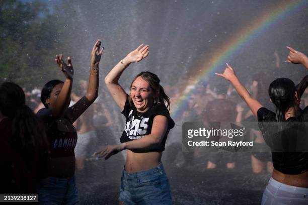 University of South Carolina students celebrate on campus in the Thomas Cooper Library reflecting pool after the Gamecocks beat the Iowa Hawkeyes in...