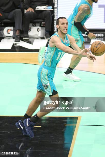 Aleksej Pokusevski of the Charlotte Hornets passes the ball during the game against the Portland Trail Blazers on April 7, 2024 at Spectrum Center in...