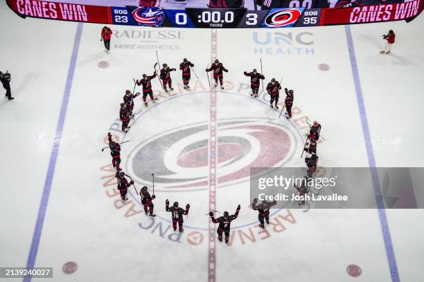 The Carolina Hurricanes celebrate with a Storm Surge after a 3-0 victory against the Columbus Blue Jackets at PNC Arena on April 7, 2024 in Raleigh,...