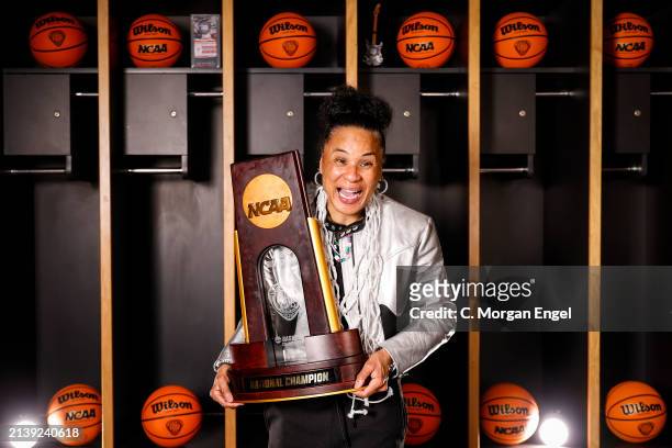 Head coach Dawn Staley of the South Carolina Gamecocks poses with the trophy after defeating the Iowa Hawkeyes during the NCAA Women's Basketball...