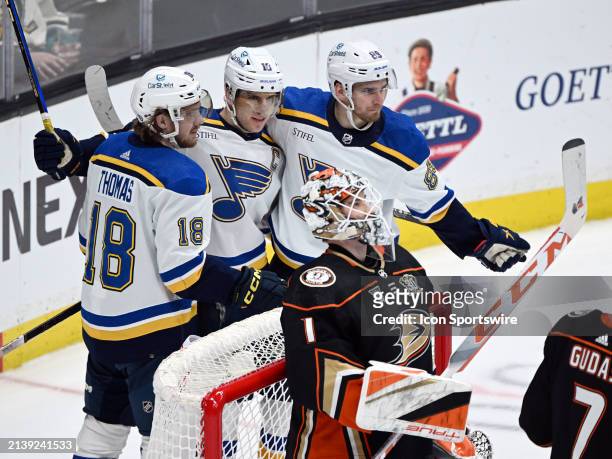 St. Louis Blues players celebrate behind Anaheim Ducks goalie Lukas Dostal after Blues center Robert Thomas scored a goal in the second period of an...