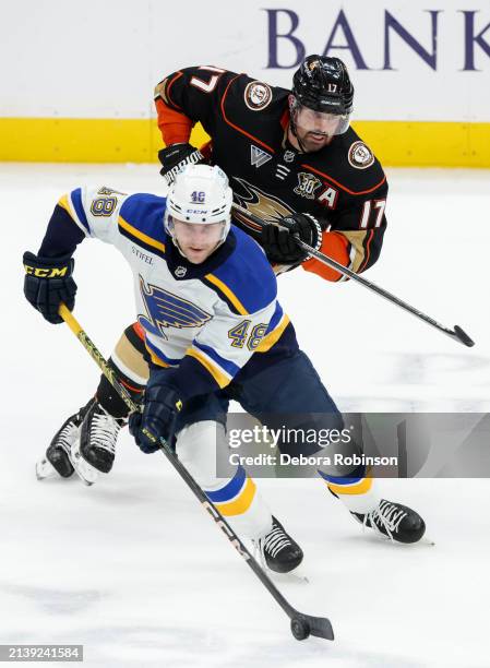 Scott Perunovich of the St. Louis Blues skates with the puck with pressure from Alex Killorn of the Anaheim Ducks during the second period at Honda...