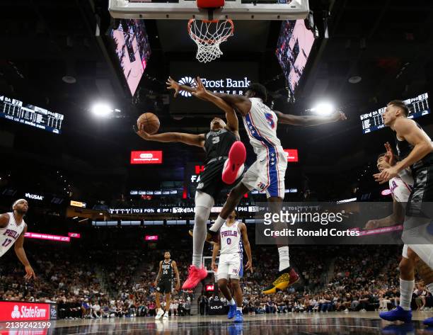 Keldon Johnson of the San Antonio Spurs drives under Mo Bamba of the Philadelphia 76ers in the first half at Frost Bank Center on April 7, 2024 in...