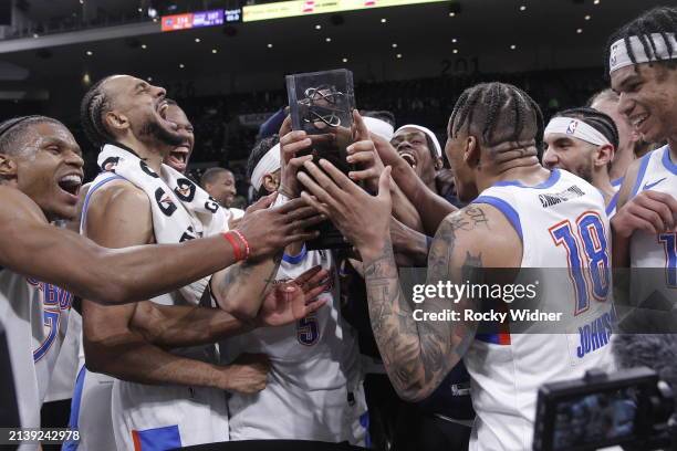 Oklahoma City Blue players celebrate with the G-League Western Conference Finals trophy after defeating the Stockton Kings during the G-League...