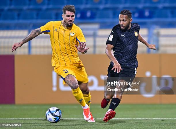 Lyanco Vojnovic of Al-Gharafa SC is battling for the ball with Kenji Joel of Umm Salal SC during the EXPO Stars League 23/24 match between Al-Gharafa...