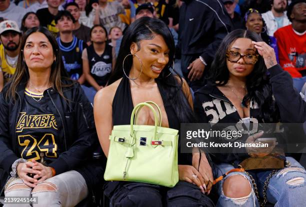 Rapper Megan Thee Stallion, holding her Birkin bag, attends a game between the Minnesota Timberwolves and Los Angeles Lakers at Crypto.com Arena on...
