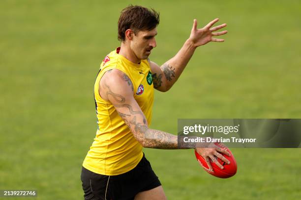 Sam Naismith of the Tigers kicks the ball during a Richmond Tigers AFL training session at Punt Road Oval on April 05, 2024 in Melbourne, Australia.