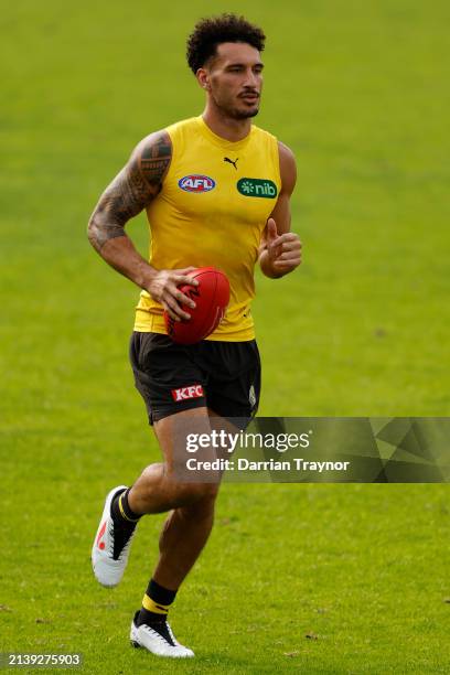 Mykelti Lefau of the Tigers runs with the ball during a Richmond Tigers AFL training session at Punt Road Oval on April 05, 2024 in Melbourne,...