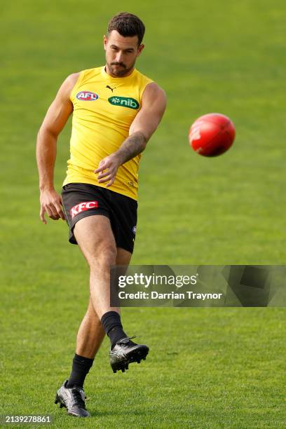 Jack Graham of the Tigers kicks the ball during a Richmond Tigers AFL training session at Punt Road Oval on April 05, 2024 in Melbourne, Australia.