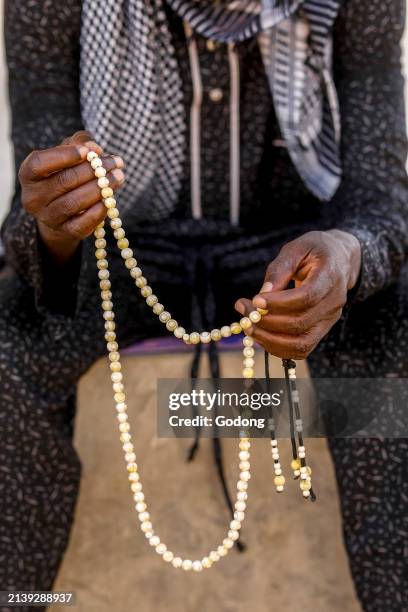 Man with prayer beads in Touba, Senegal.