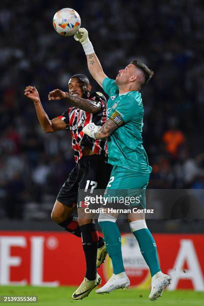 André Silva of Sao Paulo jumps for the ball with Guido Herrara of Talleres during the Copa CONMEBOL Libertadores Group B match between Talleres and...